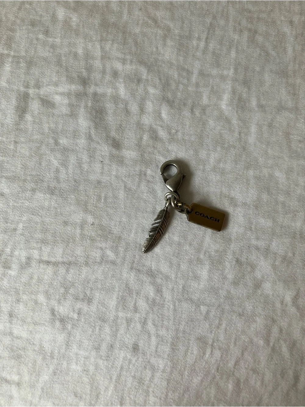 Coach: Silver Tone & Gold Tone Feather Charm Keyring